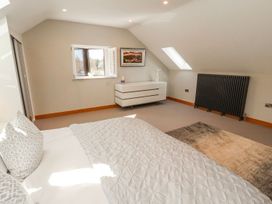 A bedroom with a bed and window at Midways in Windermere