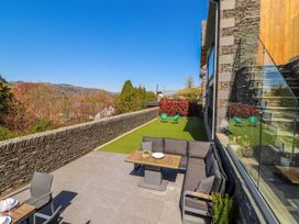 An outdoor area with a couch and table at Midways in Windermere