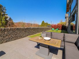An outdoor seating area with a table and couch at Midways in Windermere