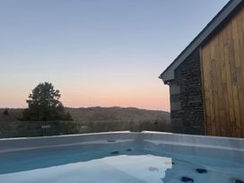 A hot tub with a view of the mountains at Midways in Windermere