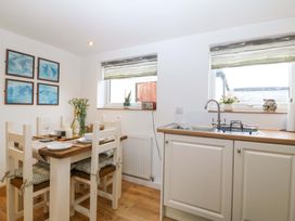 A kitchen with a dining table and tableware at Ty Loti