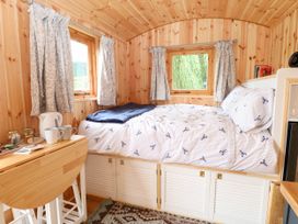 A bedroom with a bed and windows at Laurel near Littleport