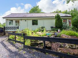 A cabin with a garden at Bull Rush Cabin Carwinley near Longtown