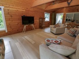 A living room with a television and seating area at Bull Rush Cabin in Carwinley near Longtown