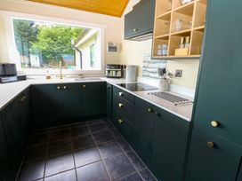 A kitchen with cabinets, countertop and appliances at Bull Rush Cabin in Carwinley near Longtown