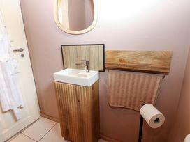 A bathroom with a sink and towel rack at Bull Rush Cabin in Carwinley near Longtown