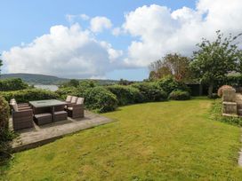 A garden with seating area at Red Wharf Retreat near Red Wharf Bay