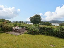 A garden with outdoor furniture at Red Wharf Retreat in Red Wharf Bay near Benllech