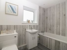 A bathroom with a sink and bathtub at Red Wharf Retreat in Red Wharf Bay near Benllech