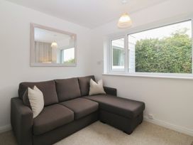 A living room with a sofa and window at Red Wharf Retreat Red Wharf Bay near Benllech