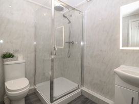 A bathroom with a shower, toilet, and sink at Red Wharf Retreat in Red Wharf Bay near Benllech