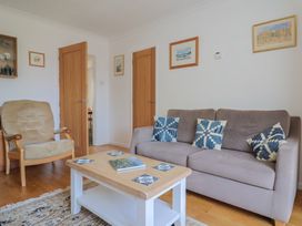 A living room with a sofa and armchair at Seaview in Lyme Regis
