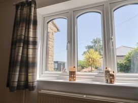 A living room with a window displaying house figurines at Seaview in Lyme Regis