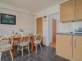 A dining room with a wooden table and chairs at Seaview in Lyme Regis