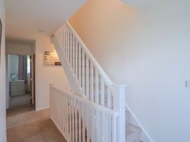 A hallway with a staircase and a door at Seaview in Lyme Regis