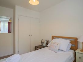 A bedroom featuring a bed and a wardrobe at Seaview in Lyme Regis