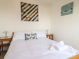 A bedroom with a bed and bedside table at Seaview in Lyme Regis