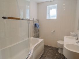 A bathroom with a bathtub, toilet, and sink at Seaview in Lyme Regis