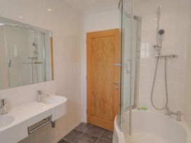 A bathroom with a shower and two sinks at Seaview in Lyme Regis