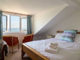 A bedroom with bed and chairs at Seaview in Lyme Regis
