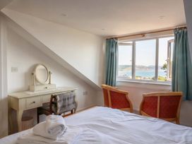 A bedroom with a view and furniture at Seaview in Lyme Regis