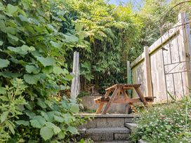 A garden with a wooden bench and steps at Seaview in Lyme Regis