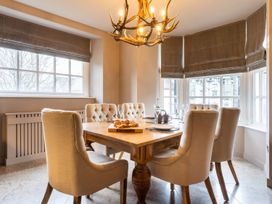 A dining room with a table and chairs at Prospect House in Windermere