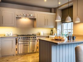 A kitchen with modern appliances and a breakfast tray at Prospect House Windermere