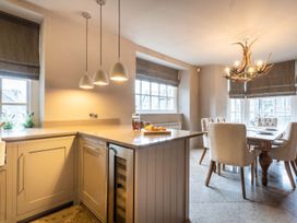 A kitchen with a countertop and dining table at Prospect House in Windermere