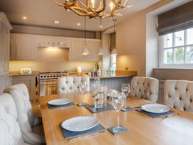 A dining room with a table and chairs at Prospect House in Windermere