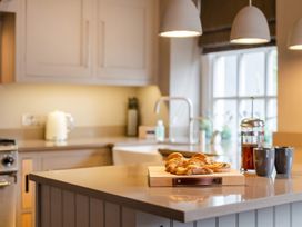 A kitchen with croissants and coffee on a table at Prospect House in Windermere
