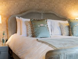 A bed with pillows and a water bottle at Prospect House Windermere