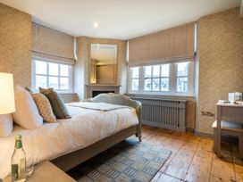 A bedroom with a bed and window at Prospect House in Windermere