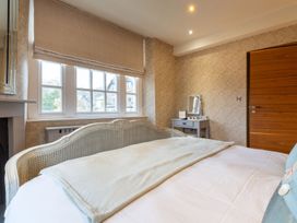 A bedroom with a bed and dressing table at Prospect House in Windermere