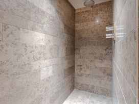 A shower area with tiled walls at Prospect House Windermere