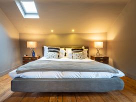A bedroom with a bed and nightstands at Prospect House in Windermere