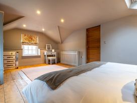 A bedroom with a bed, desk, and window at Prospect House in Windermere