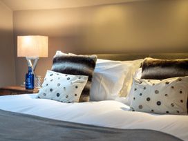 A bedroom with a bed and pillows at Prospect House in Windermere