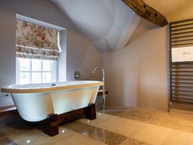 A bathroom with a bathtub and a towel rack at Prospect House Windermere