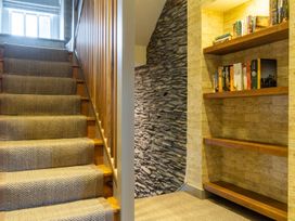 A staircase with a bookshelf at Prospect House in Windermere
