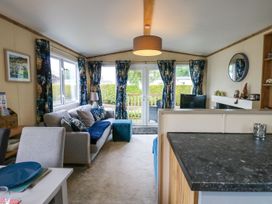 A living room with a sofa and a television at Plot 41 High Hesket near Armathwaite