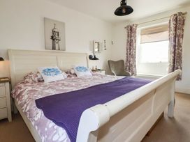 A bedroom with a double bed and bedside table at Stones Throw Mevagissey