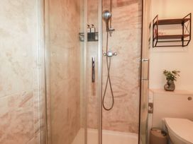 A shower with glass doors in a bathroom at Stones Throw in Mevagissey