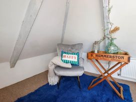 A snug with a chair and table at Stones Throw in Mevagissey