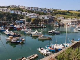 A harbor with boats and buildings in the background at Stones Throw Mevagissey