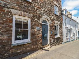 An exterior view of a stone building with windows and a door at Stones Throw in Mevagissey