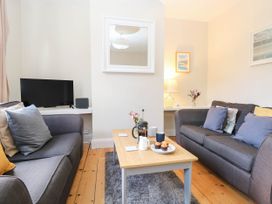 A living room with sofas and a coffee table at 19 Covert Road in Reydon