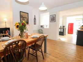 A dining room with a table set for meals at 19 Covert Road, Reydon