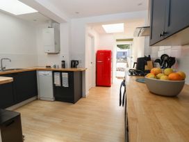A kitchen with a red refrigerator and a sink at 19 Covert Road in Reydon