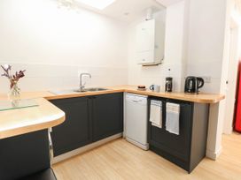 A kitchen with a sink, dishwasher, and coffee maker at 19 Covert Road, Reydon
